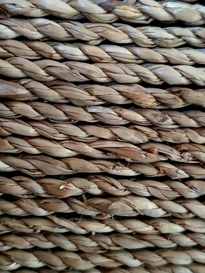Intricate close-up of a woven wicker surface showcasing natural texture and weathered patterns.